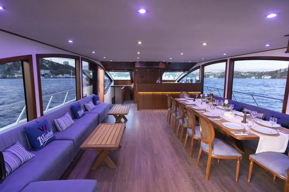 Yacht saloon with a long table for lunch