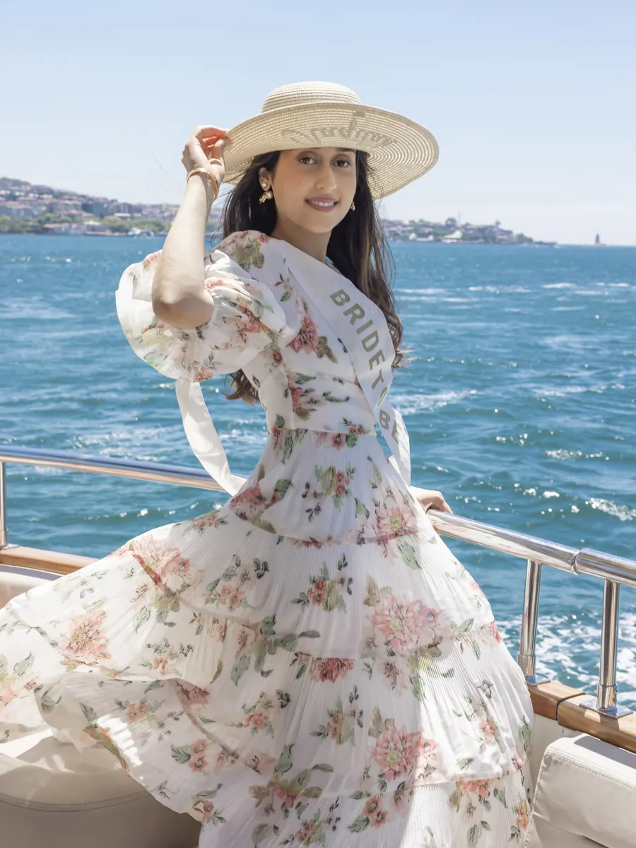 Bride to be in a floral dress on a yacht deck