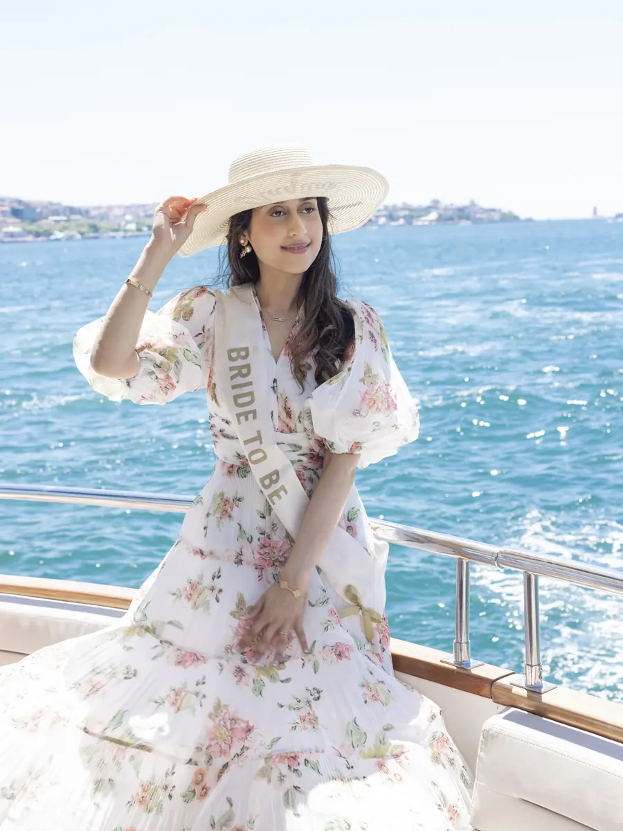Bride to be in a sun hat on a yacht
