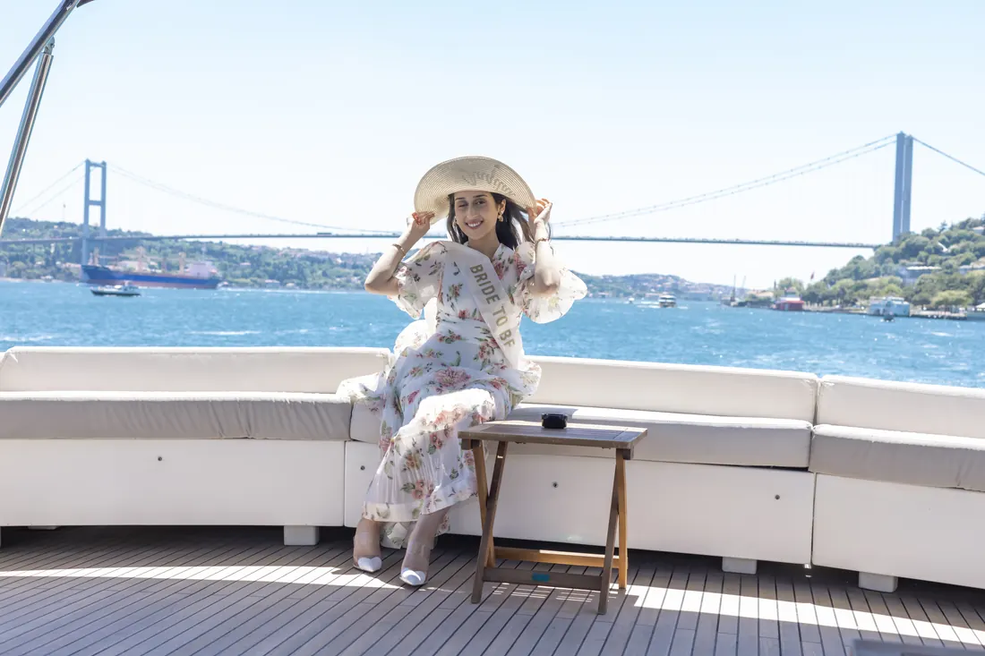 Bride to be on a yacht deck with the Bosphorus Bridge