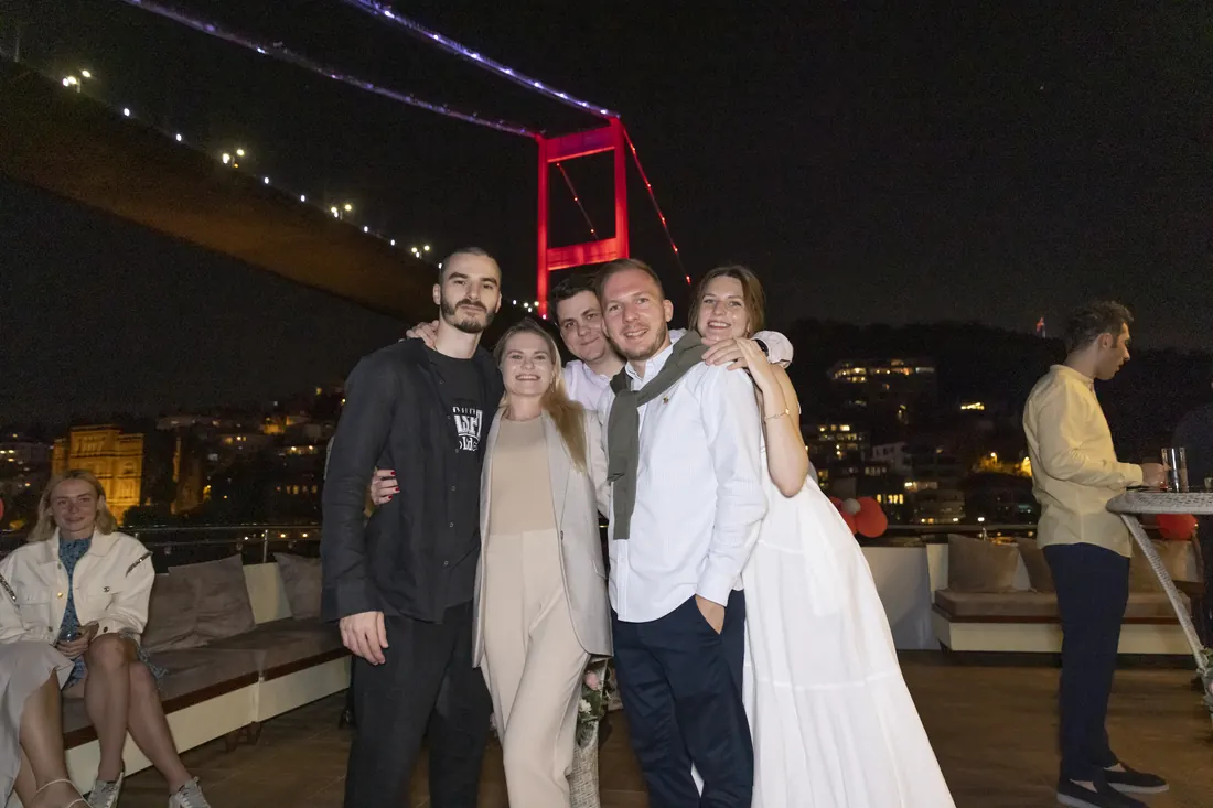 Friends at a birthday party under the Bosphorus Bridge
