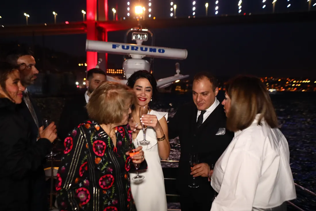 Guests raising a toast at a birthday party on a yacht