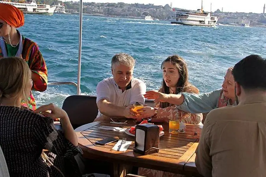 Guests at a table on the open deck