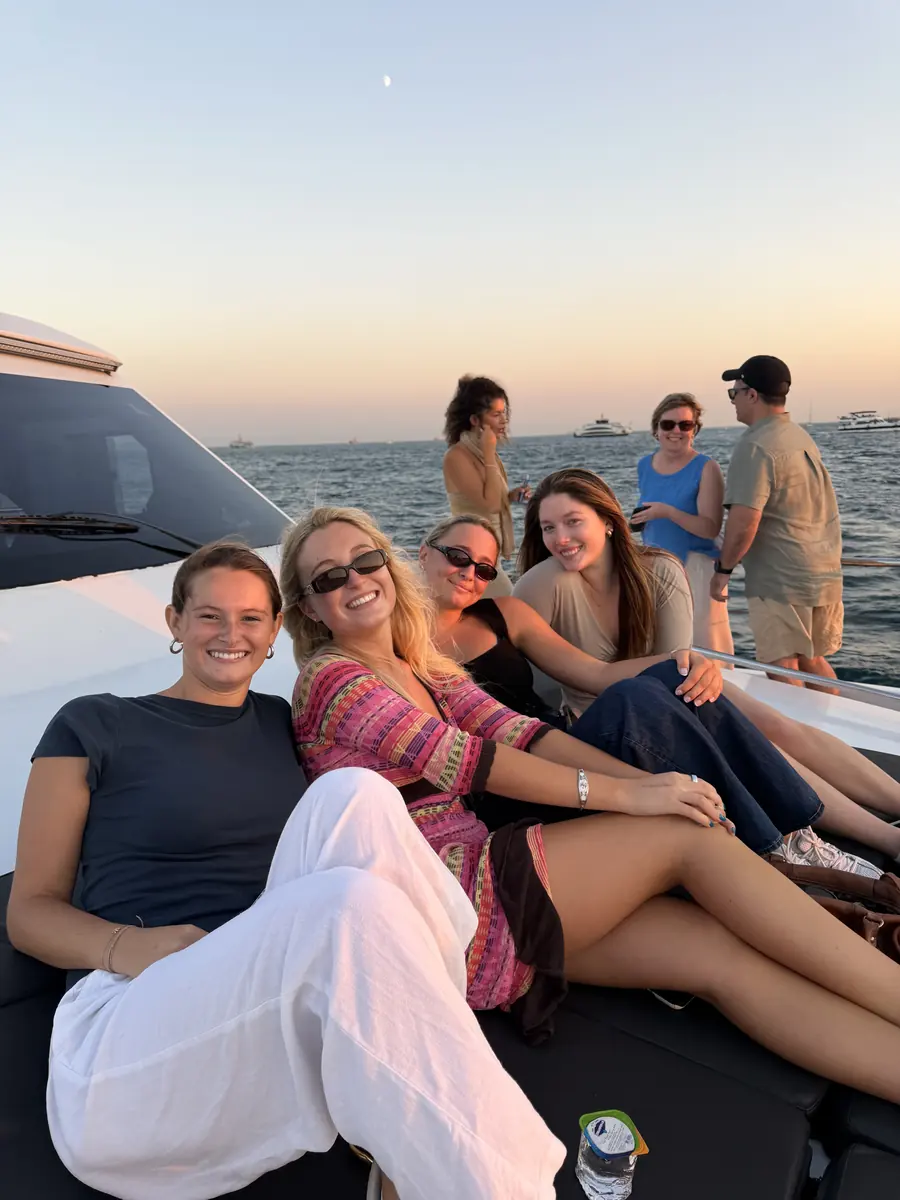 Guests relaxing on the deck cushions at sunset