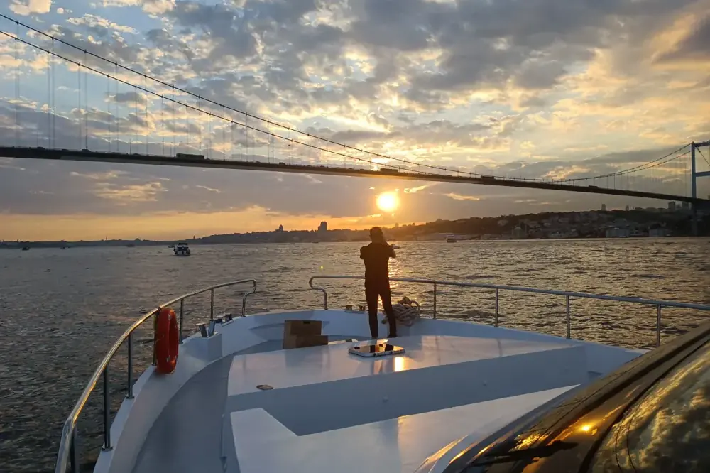 Private yacht near the Bosphorus Bridge at sunset