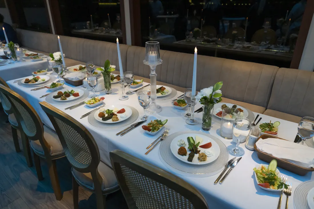Gala dinner table set with candles on a yacht