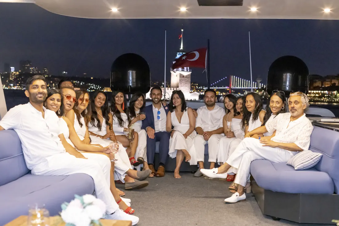 Company white party group on a yacht at night