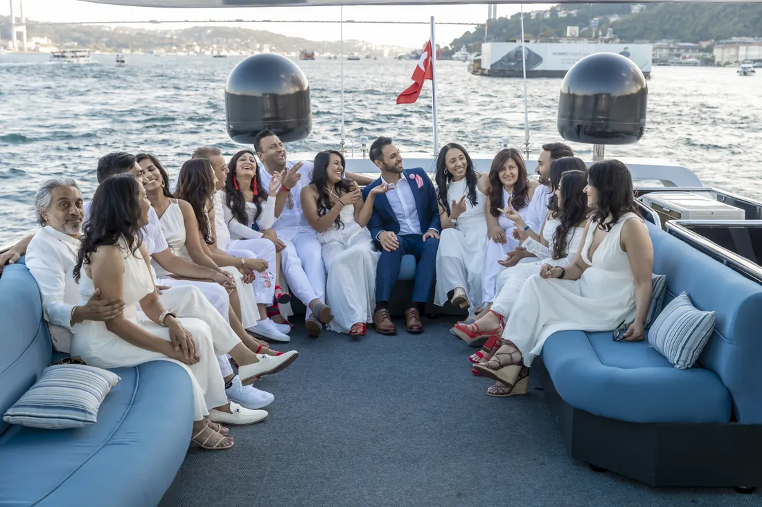 White party guests relaxing on the deck of a yacht