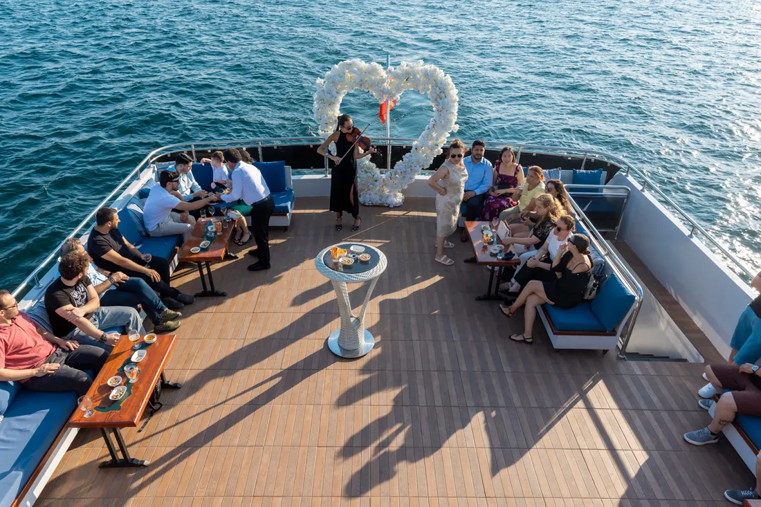 Engagement party with a heart flower arch on a yacht deck