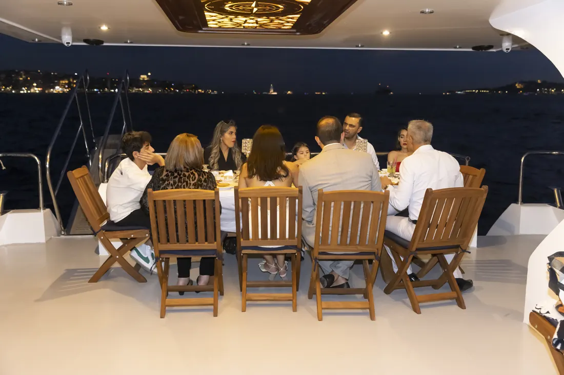 Family dinner on the aft deck of a yacht