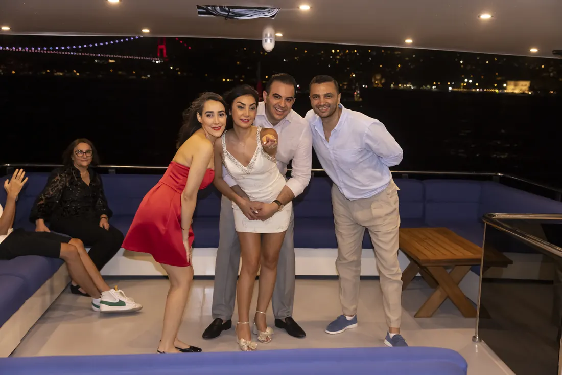 Family having fun on a yacht deck at night