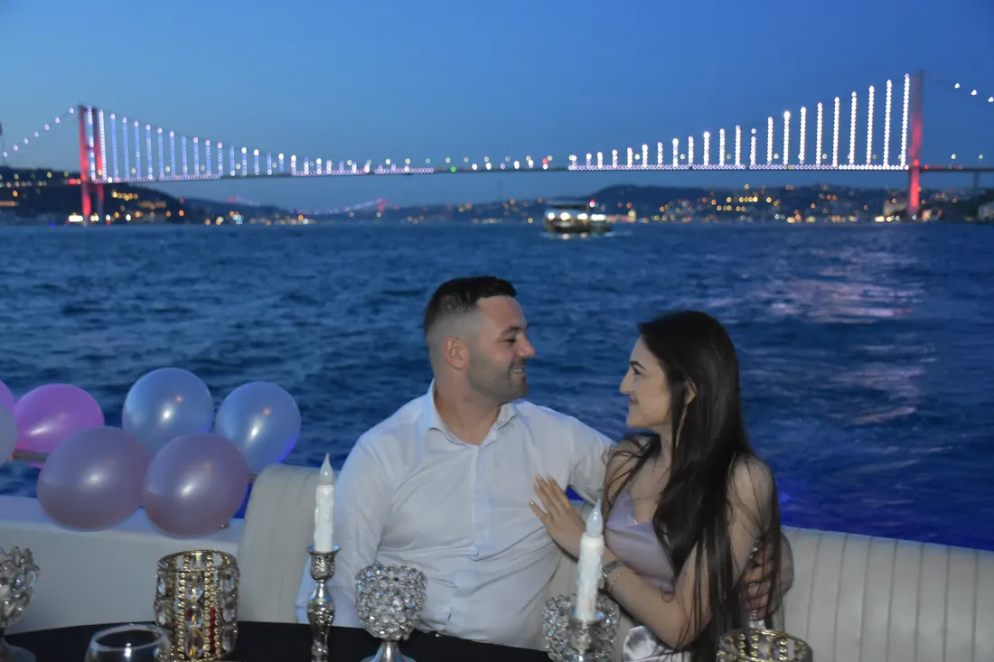 Couple with pastel balloons and candles on a yacht