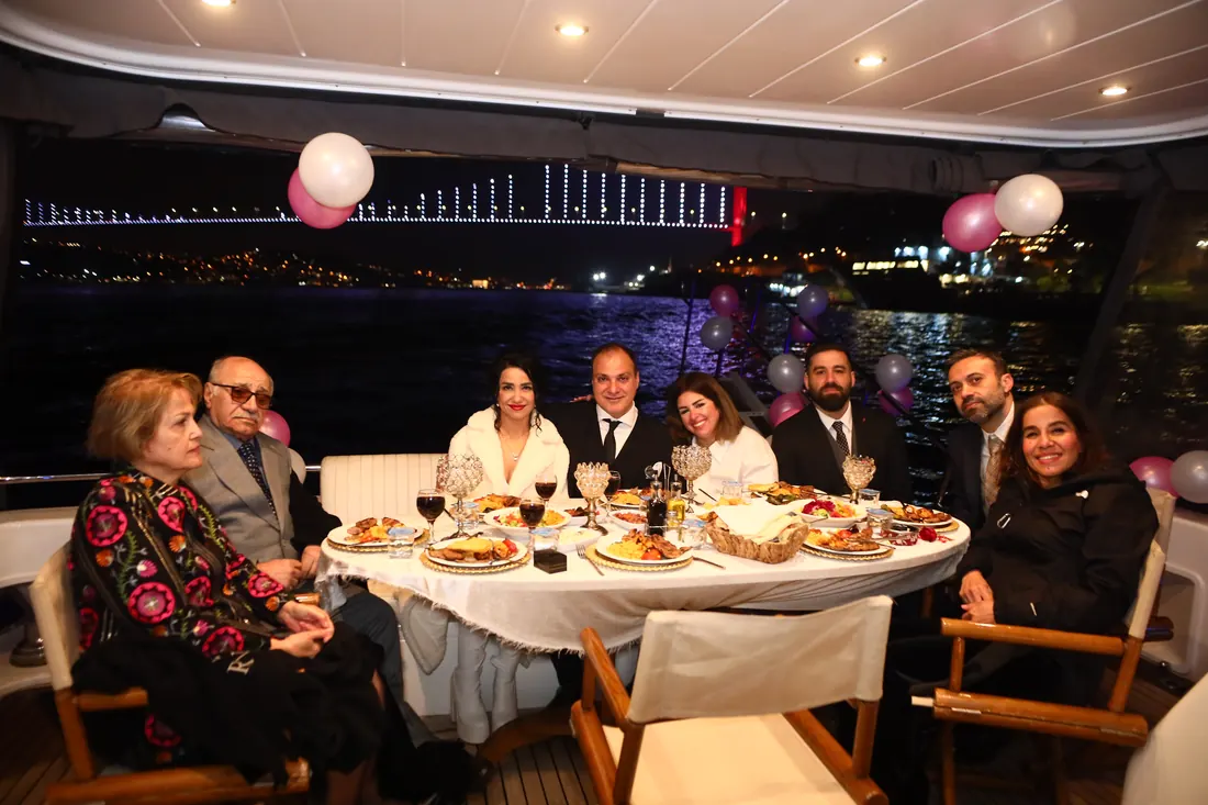 Family table with pink and white balloons on a yacht