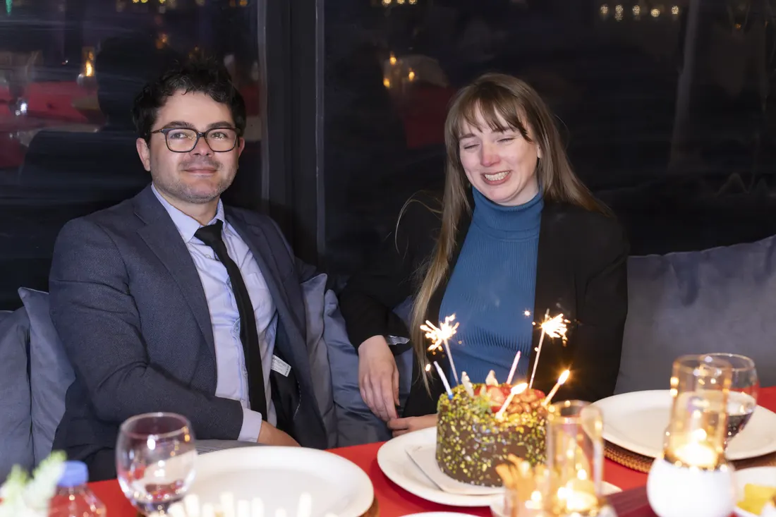 Engaged couple with a cake and sparklers on a yacht