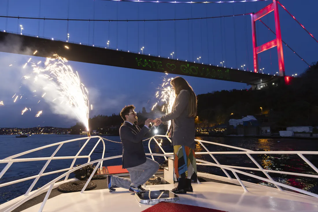 Marriage proposal with sparklers on a yacht under the Bosphorus Bridge