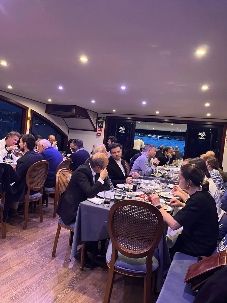 Guests at dinner in the saloon of a yacht on the Bosphorus