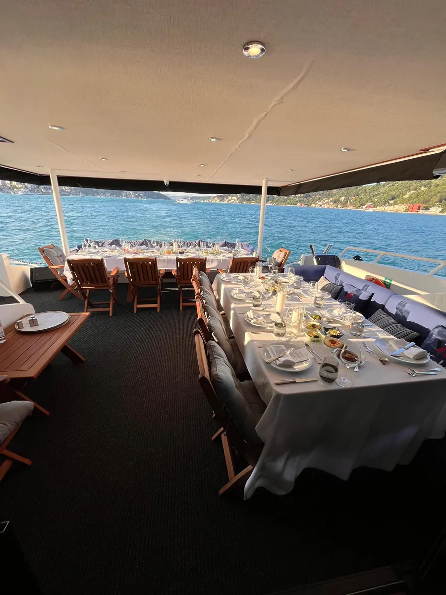 Long lunch table on the aft deck of a yacht