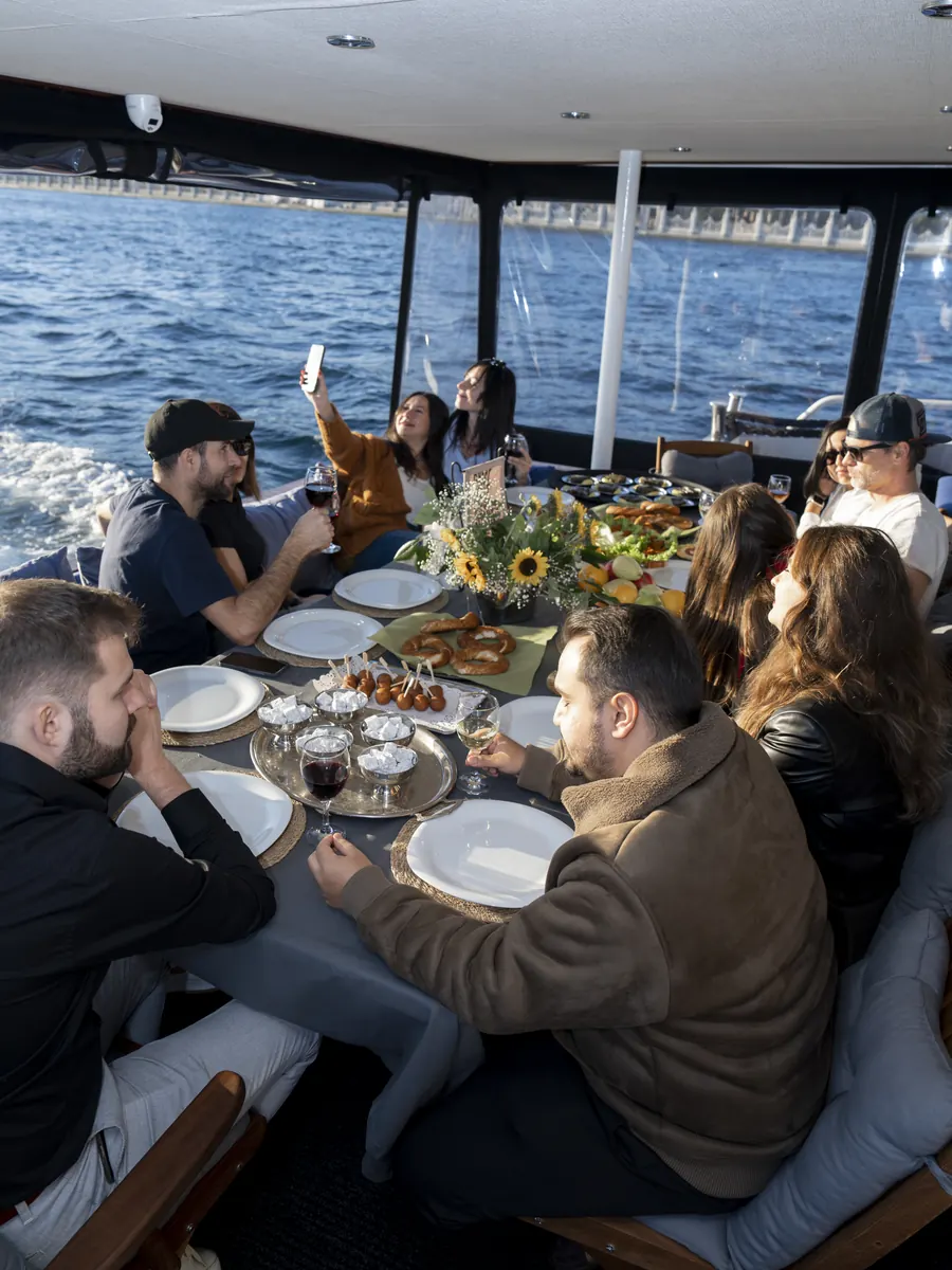 Group lunch on the covered deck of a yacht on the Bosphorus
