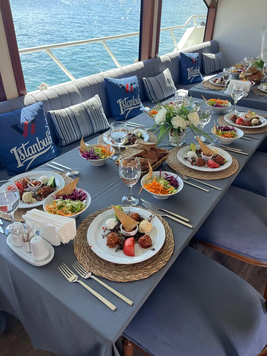 Lunch table set by the window of a private yacht