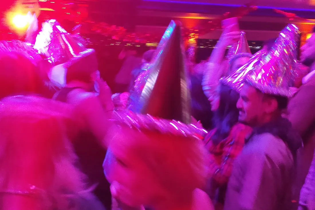 Guests in party hats on New Year's Eve