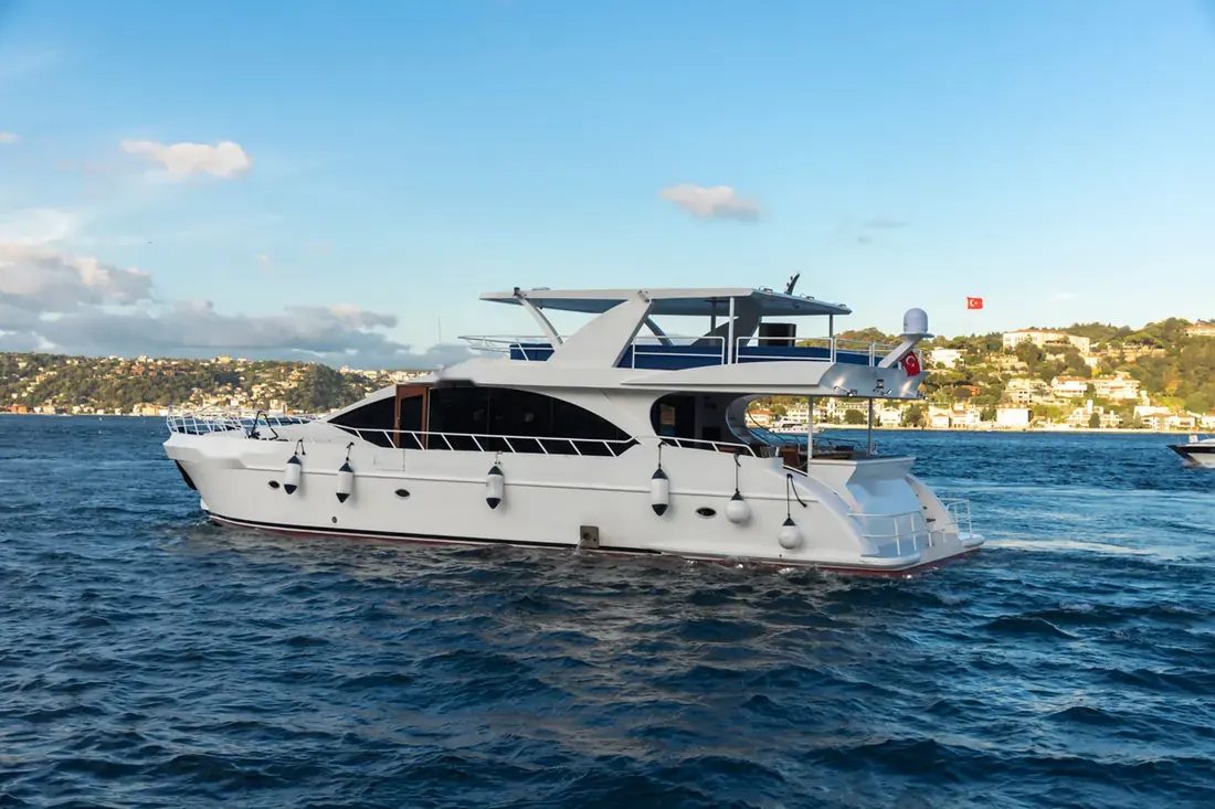 White Istanbul yacht cruising on the Bosphorus in summer