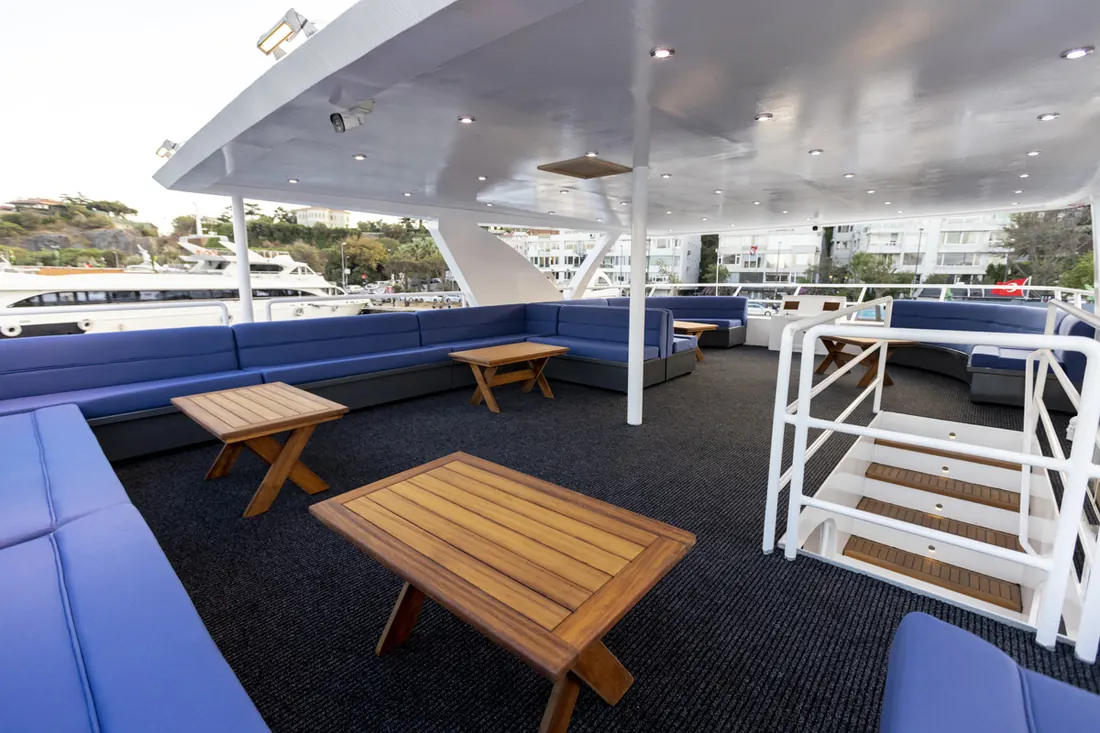 Upper deck with sofas and tables on a private yacht