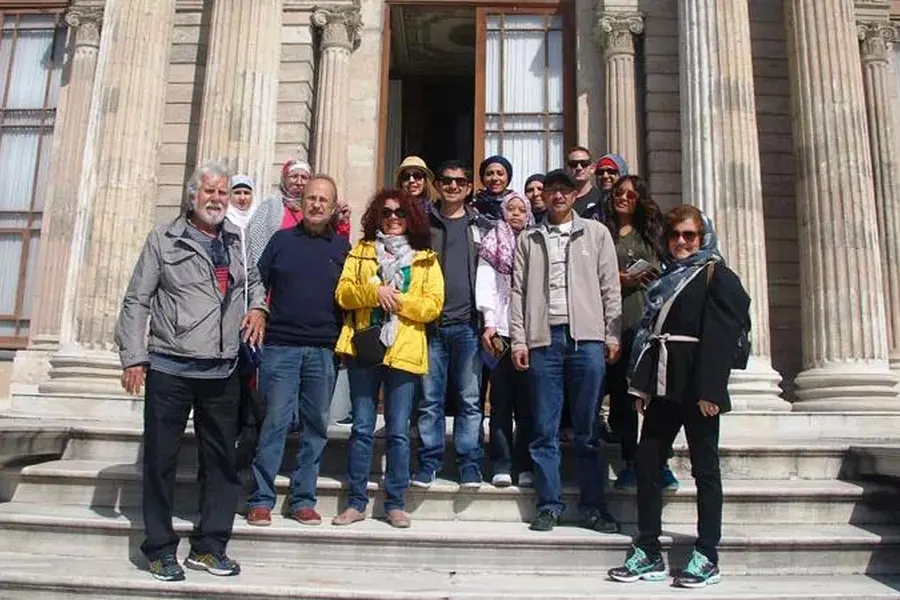Group on the steps of a palace on the tour