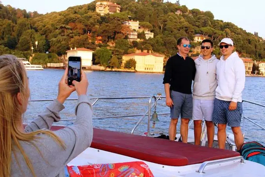 Guest taking photos from the yacht on the sunset cruise