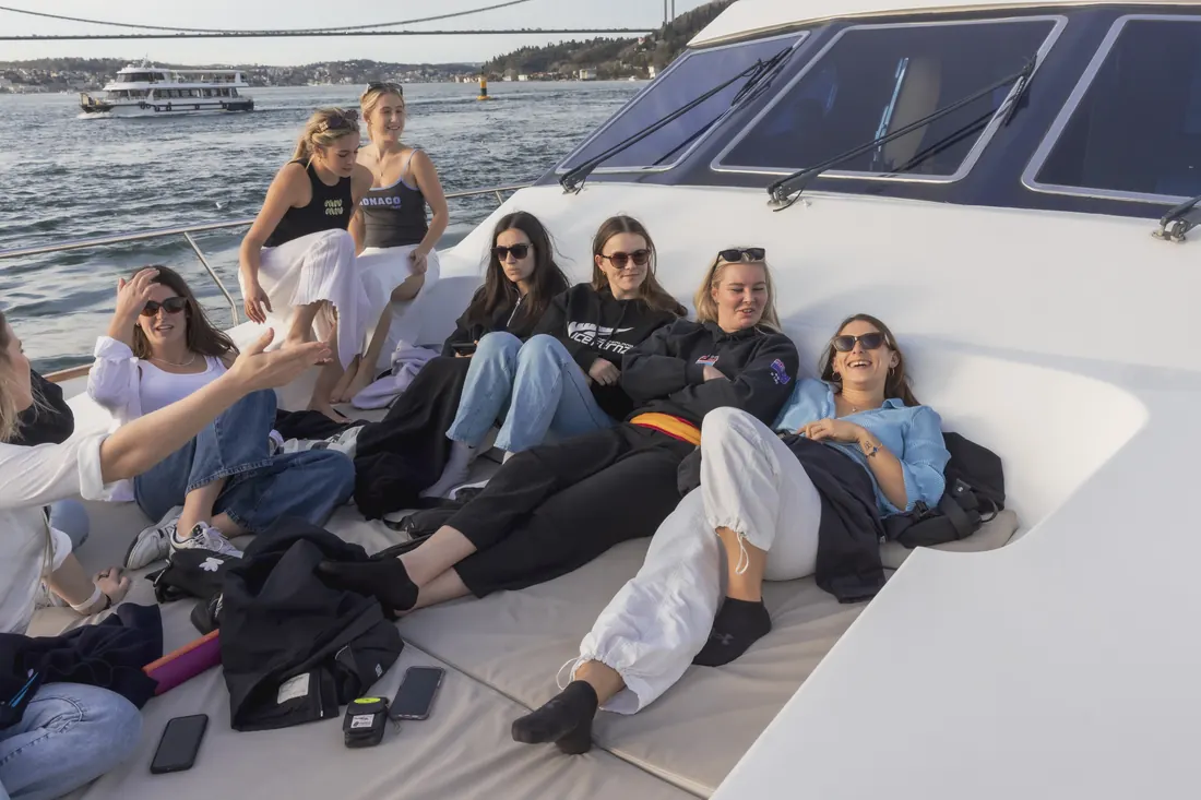 Colleagues relaxing on the sun deck of a yacht