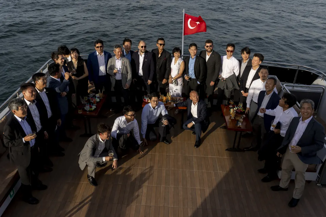 Company team on the bow of a yacht with the Turkish flag