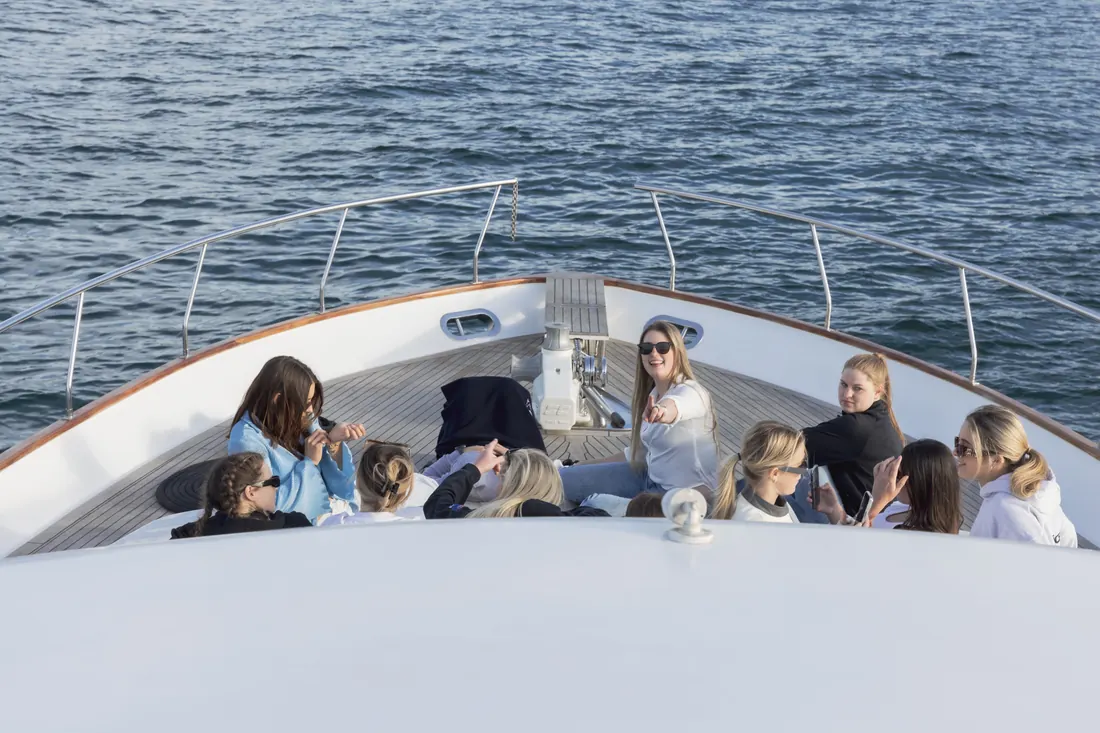 Team group on the bow of a yacht