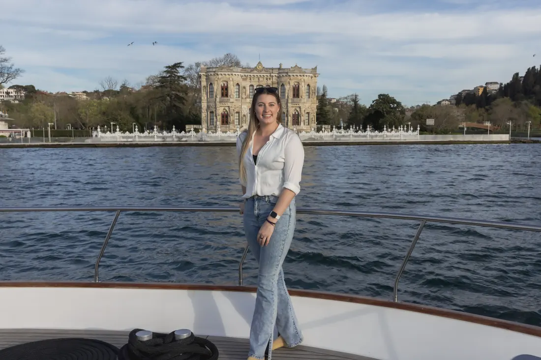 Team member on a yacht in front of Küçüksu Pavilion