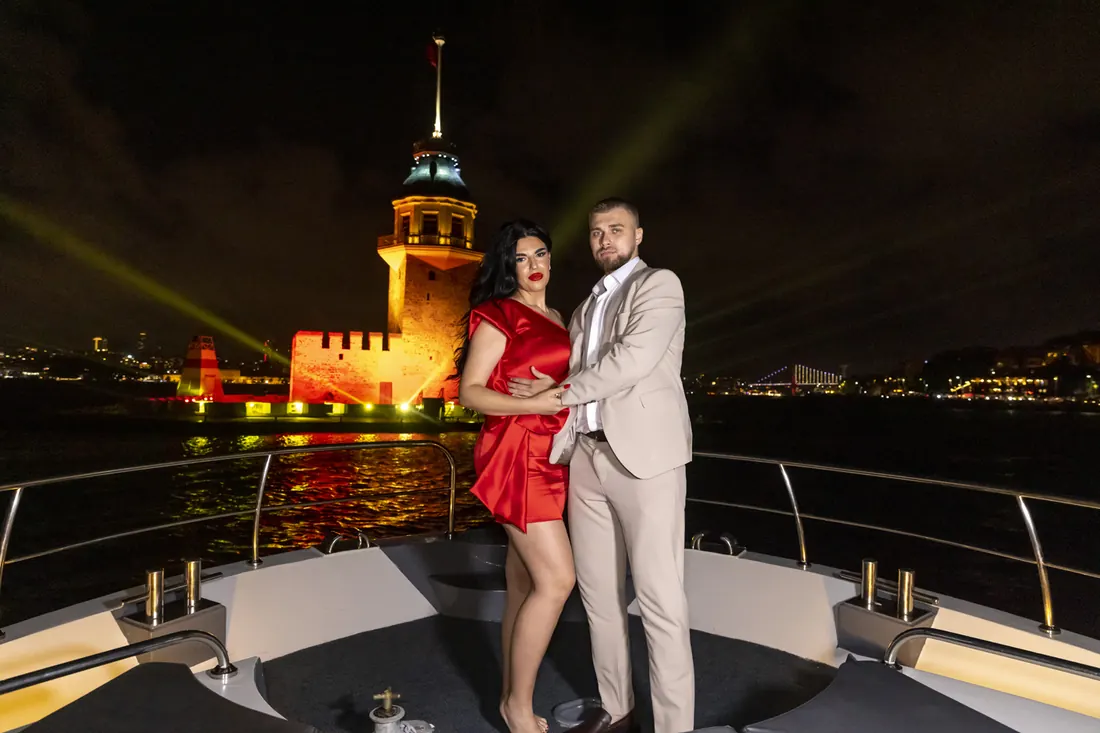 Couple on a yacht by the illuminated Maiden's Tower