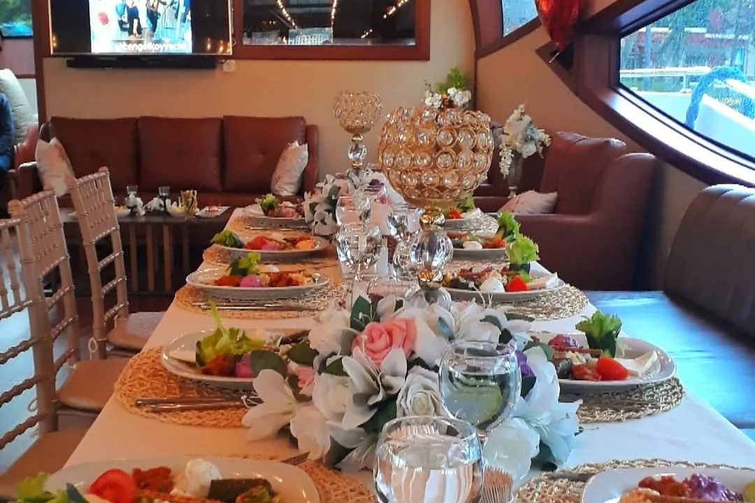 Reception table with flowers in a yacht saloon