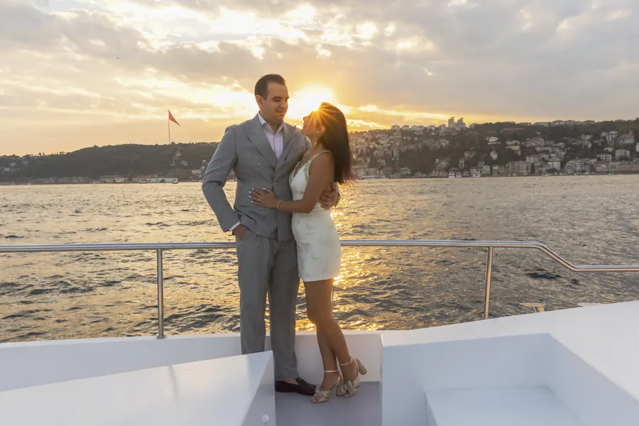 Couple celebrating their anniversary on a yacht at sunset