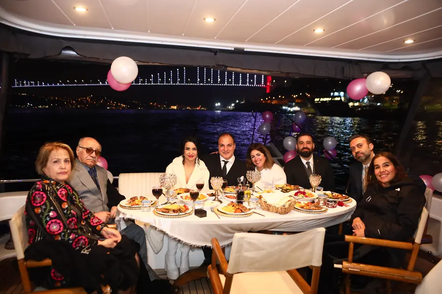 Family celebration dinner on a yacht at night
