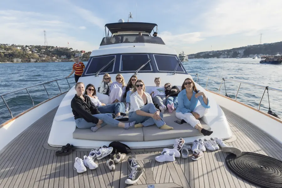 Friends relaxing on the bow of a yacht