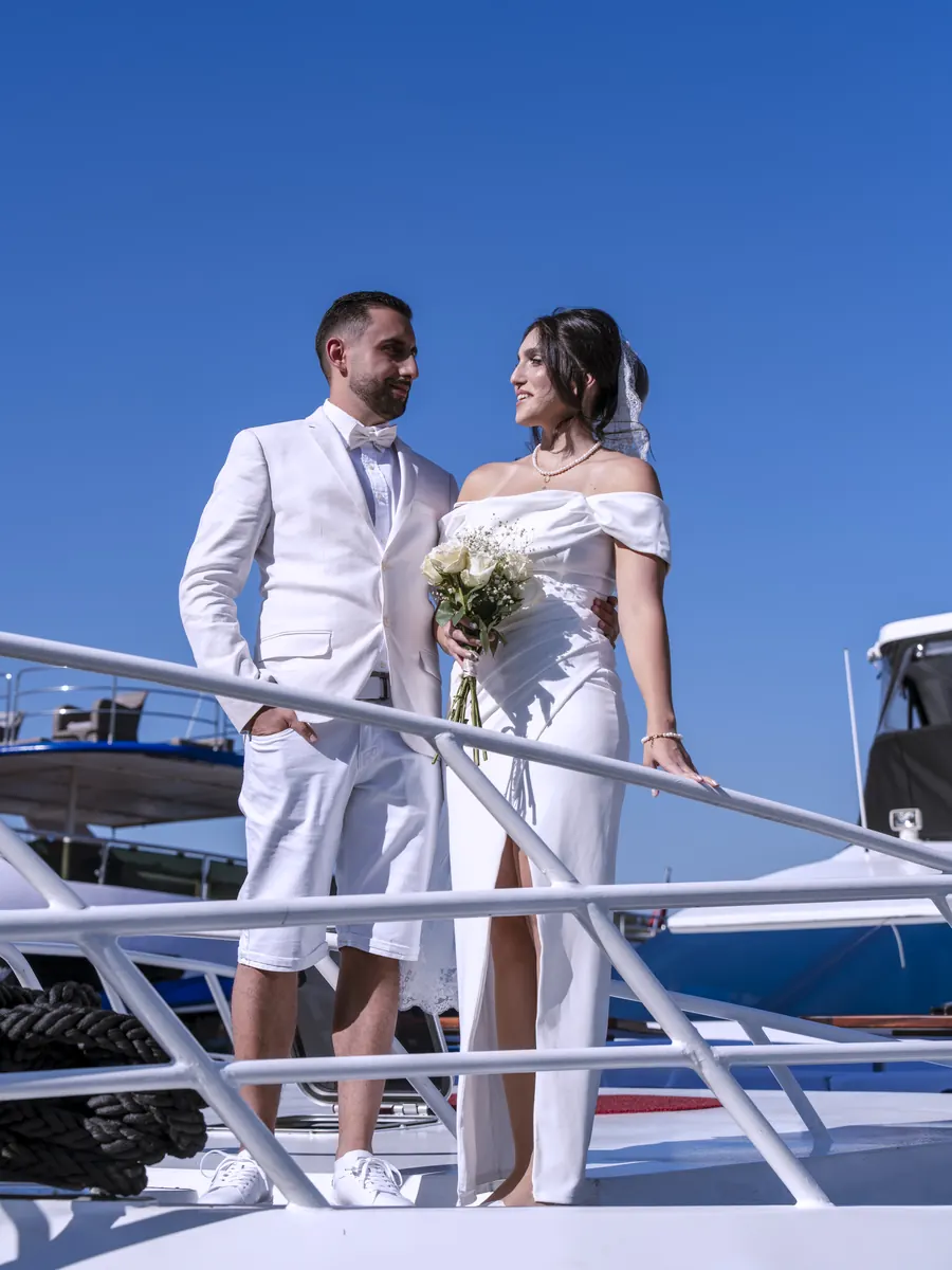 Bride and groom on the deck of a yacht