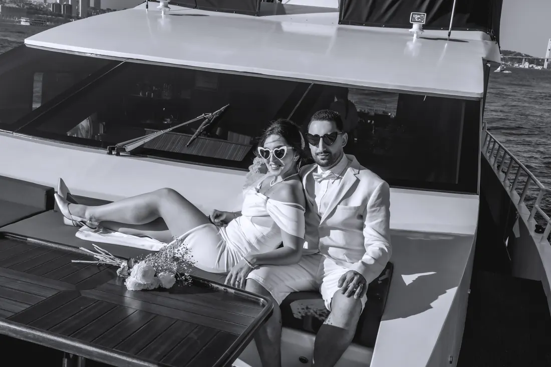 Newlyweds relaxing on a yacht deck in black and white