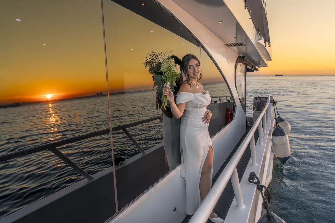 Bride on a yacht deck at sunset