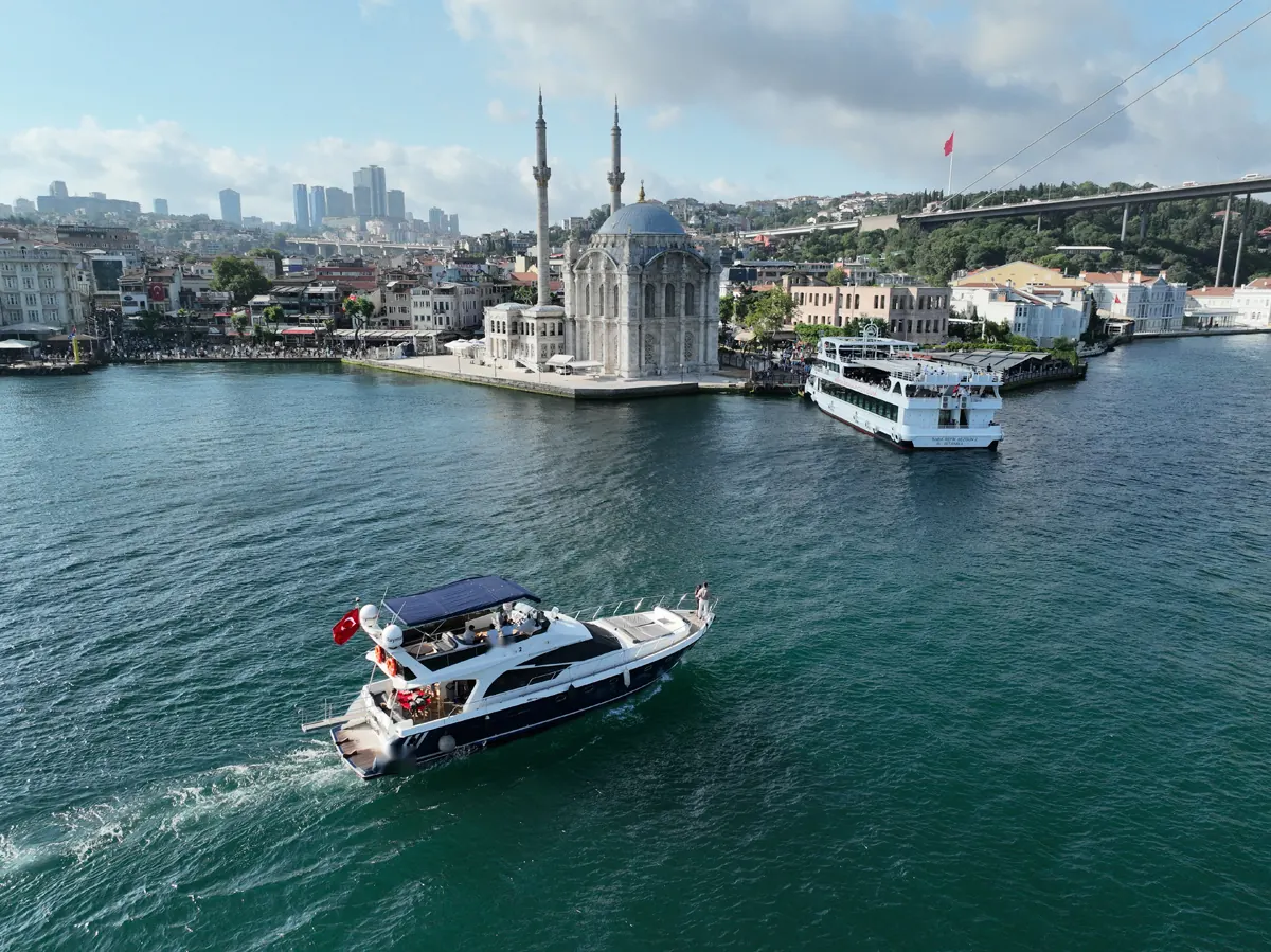 Azure yacht cruising past Ortaköy