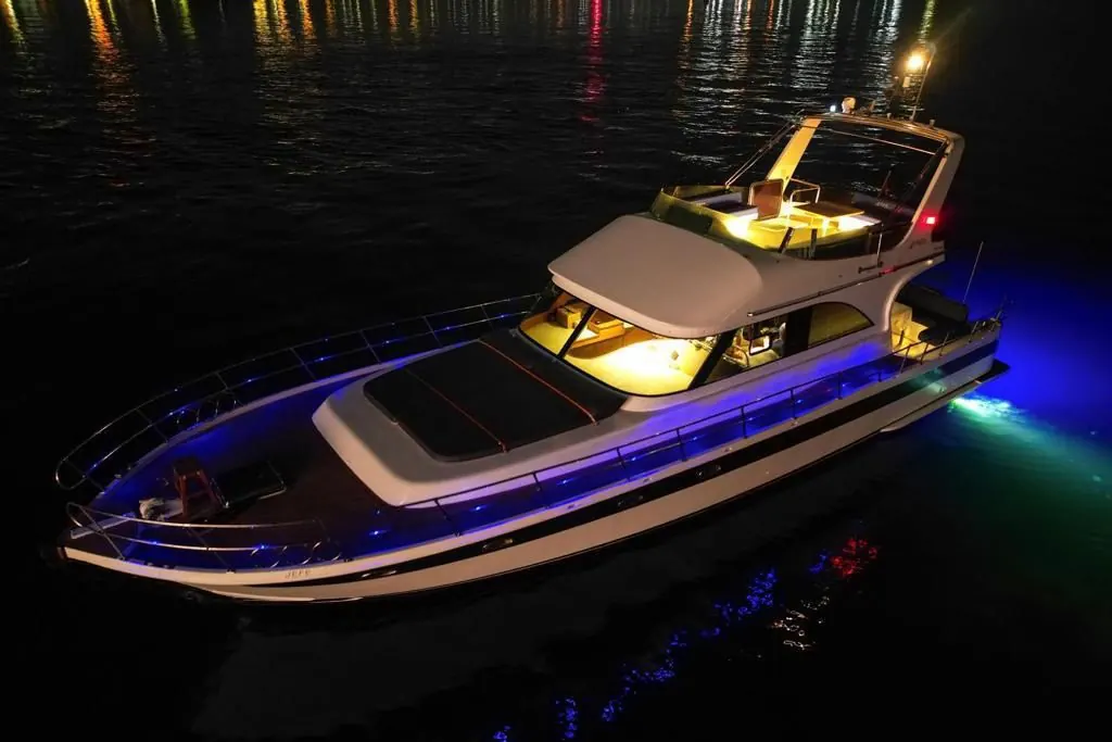 Blue Horizon yacht with underwater lights at night