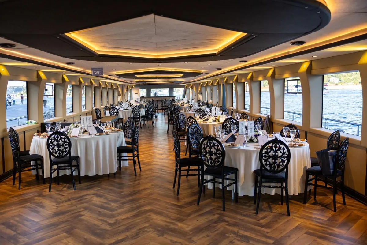 Banquet hall set with round tables on Majesty
