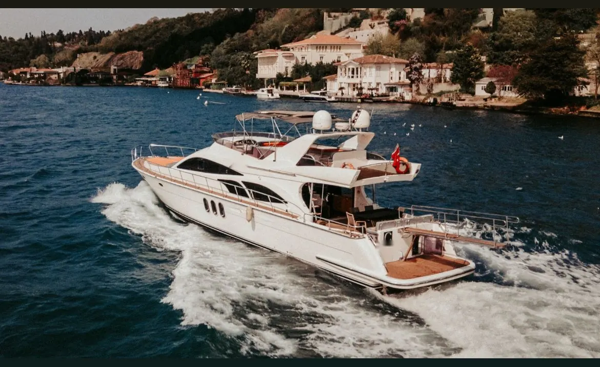 Riviera motor yacht cruising past Bosphorus mansions