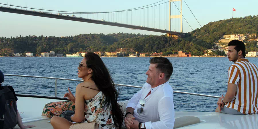 Bosphorus cruise boat on the water with Istanbul's skyline behind