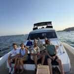 Private Bosphorus cruise by day with a group aboard a chartered boat passing Dolmabahçe Palace in Istanbul